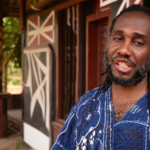 Ɔbenfo Ọbádéle Kambon at Abibitumi headquarters announcing Black August Twi classes